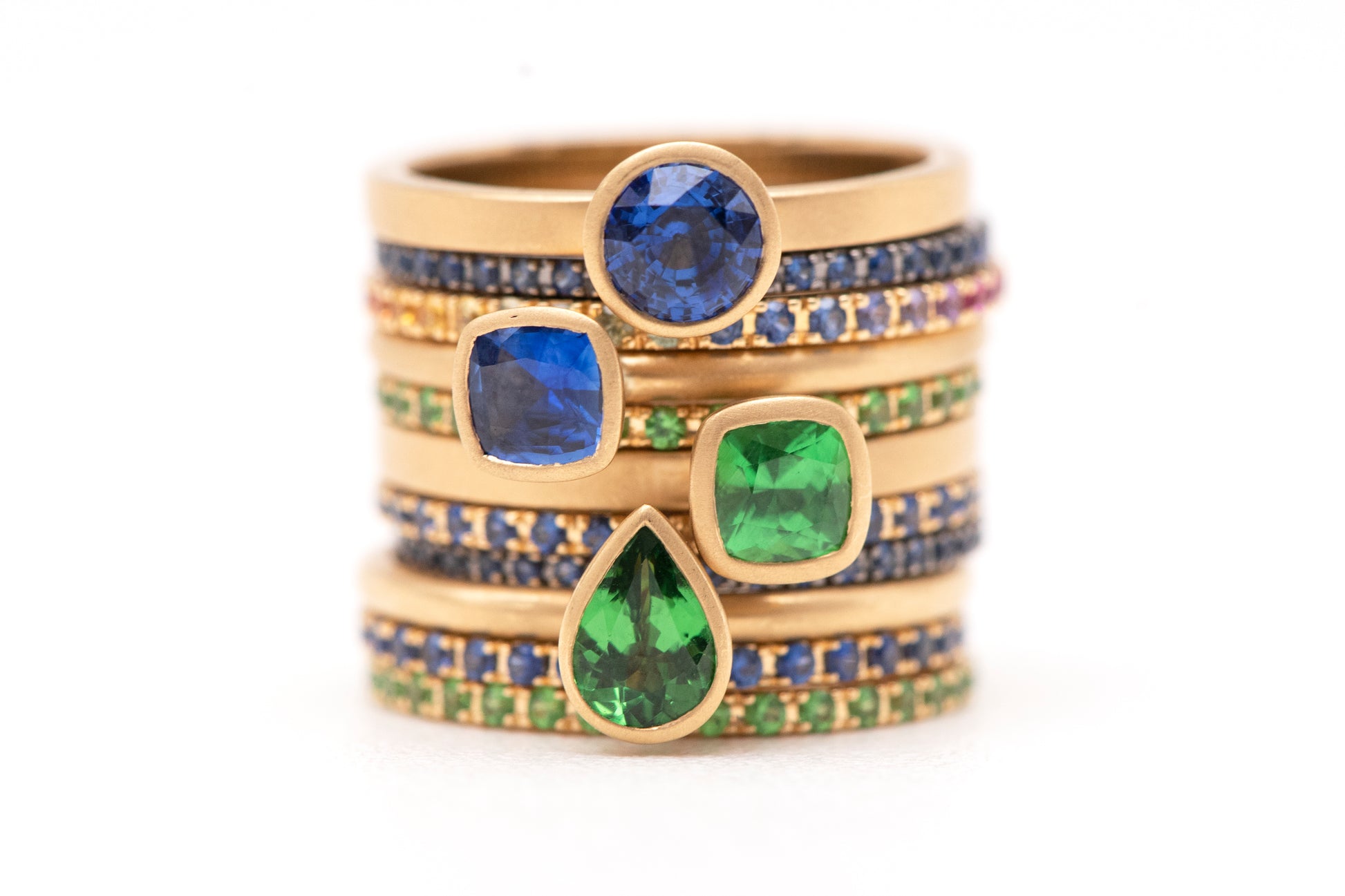 Luxurious 18 karat yellow gold stackable gemstone ring, offering endless customization with various gemstones and shapes. Perfect for creating a unique, personalized ring stack.