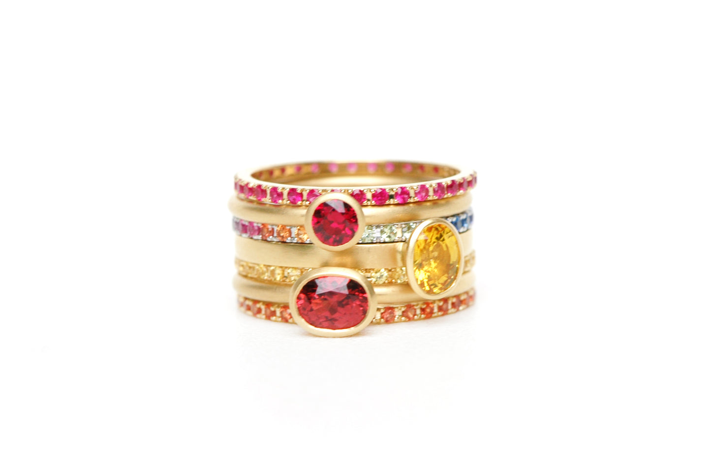 18 karat yellow gold stacking ring featuring a unique selection of gemstones and shapes, designed for luxurious and personalized stacking combinations.