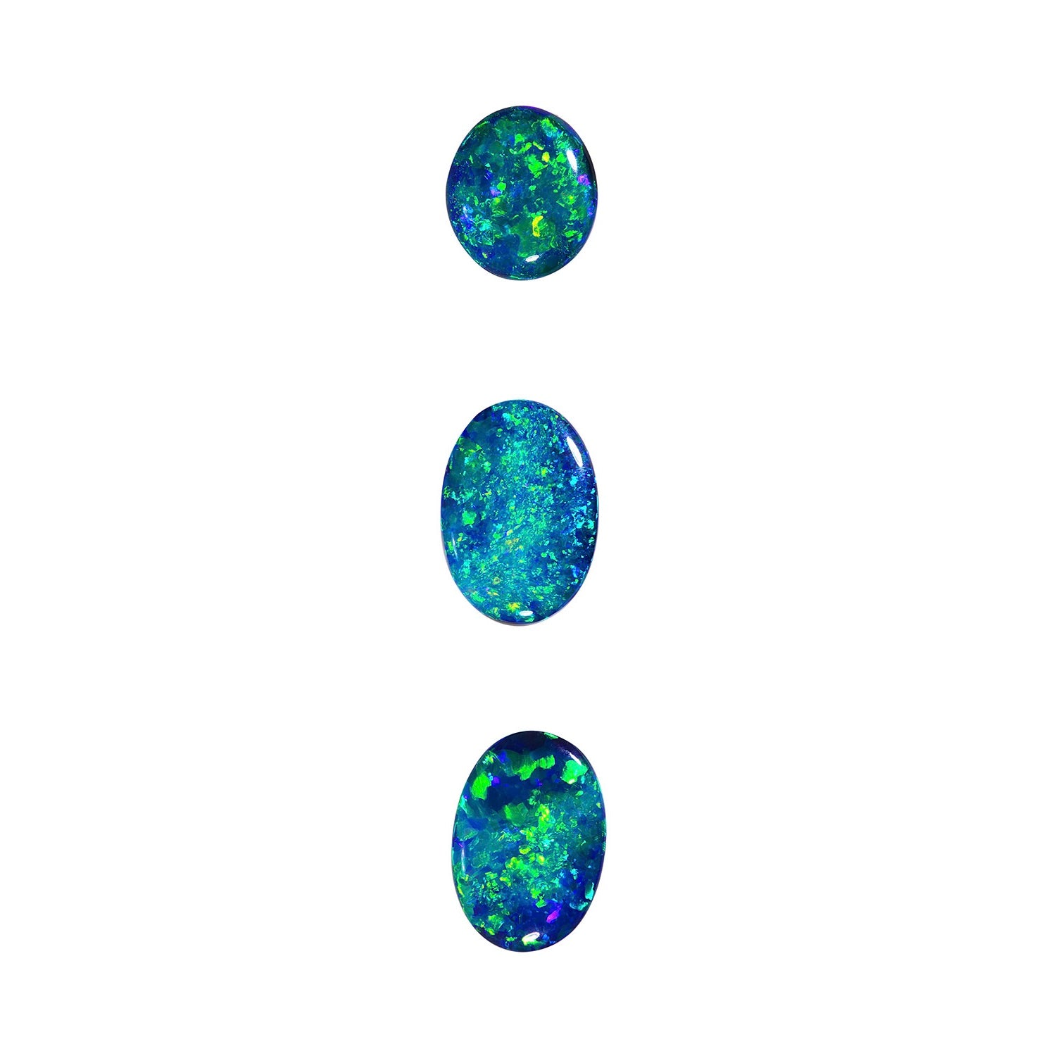 Layout of three gem quality Australian black opals with mesmerizing blues and greens. Sizes: 1.85cts (10.7 x 9 x 3.2 mm), 2.35cts (10.7 x 9.2 x 3.6 mm), and 2.56cts (13.6 x 9.6 x 3.3 mm). Perfect for a show-stopping necklace.